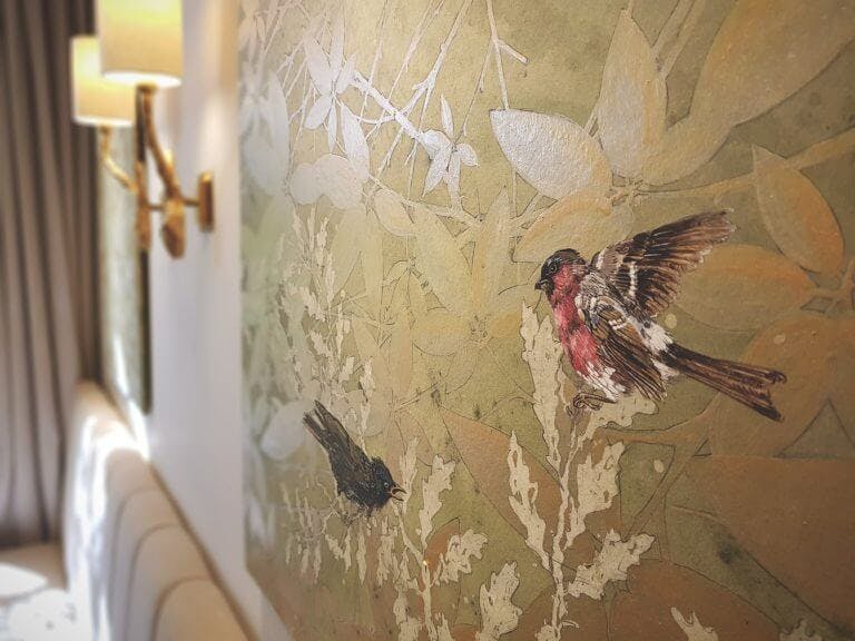 Piece of art on hotel bedroom wall showing birds on a canvas