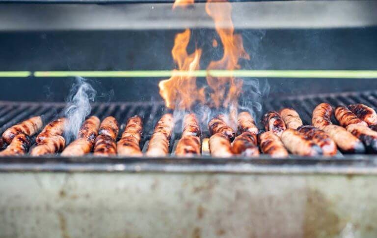 Sausages on a flaming barbeque