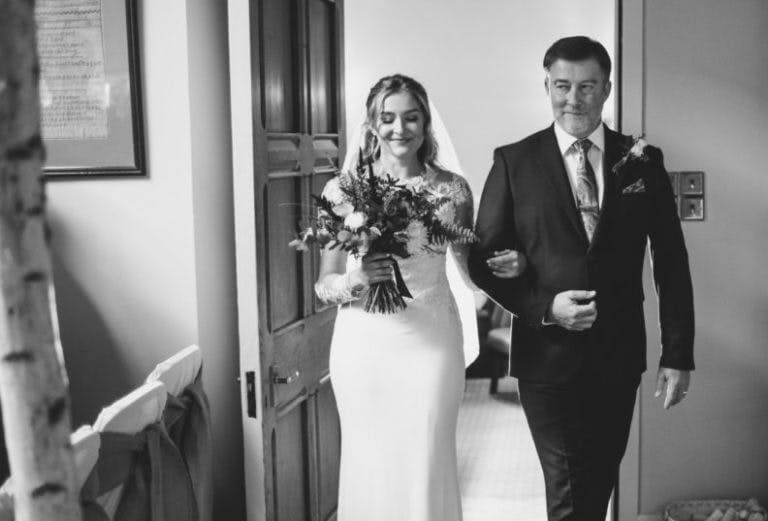 Father of the bride walking the bride into the wedding ceremony at Careys Manor.