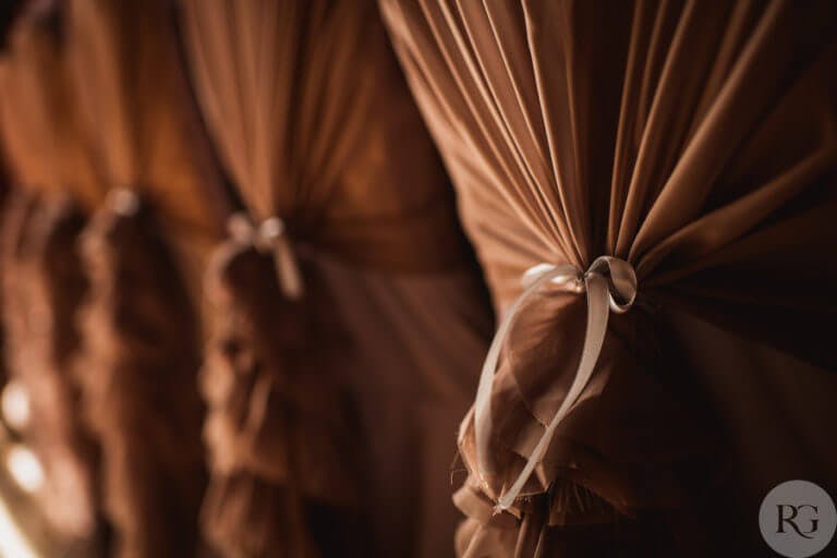 Close up of sash on wedding chairs at ceremony