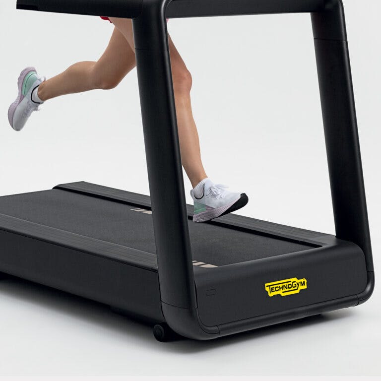 Legs running on a Technogym treadmill