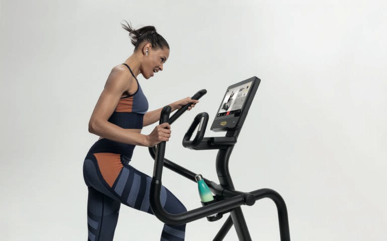 Woman working out using Technogym equipment