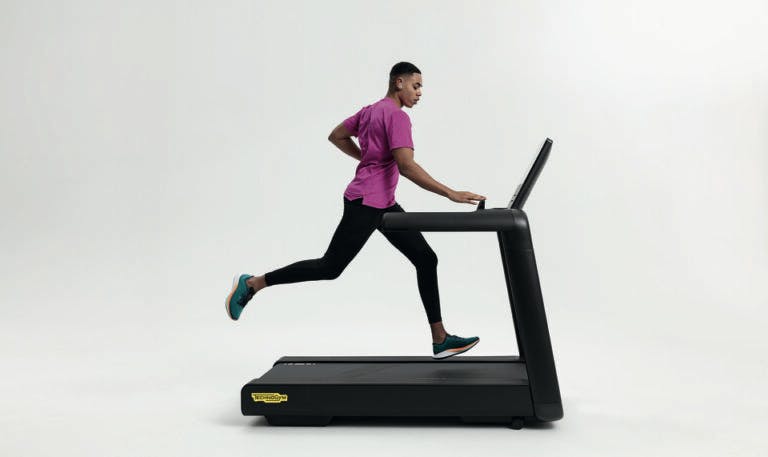 Man working out using Technogym equipment