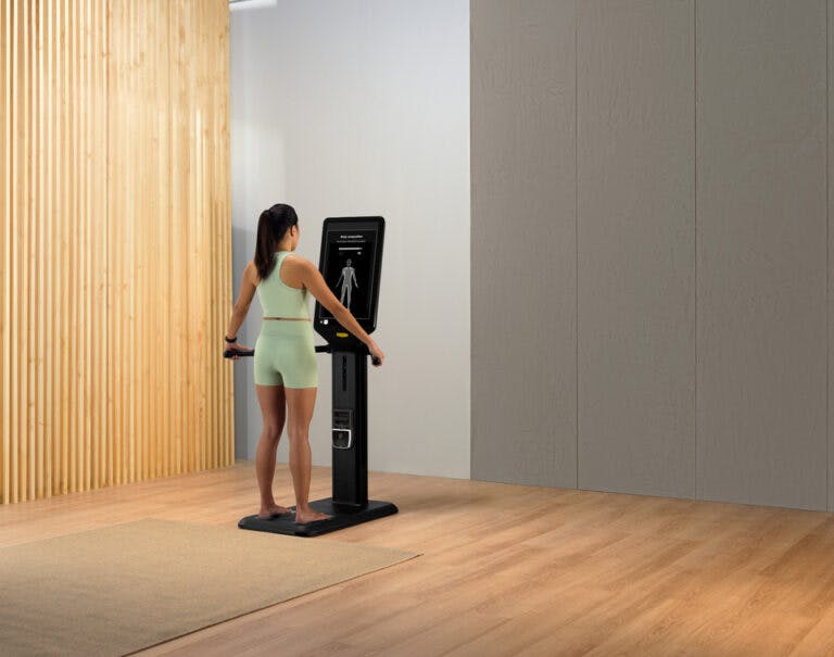 Woman having body check with Technogym Checkup equipment