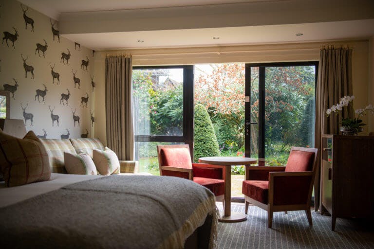Superior bedroom with a garden view at Careys Manor Hotel