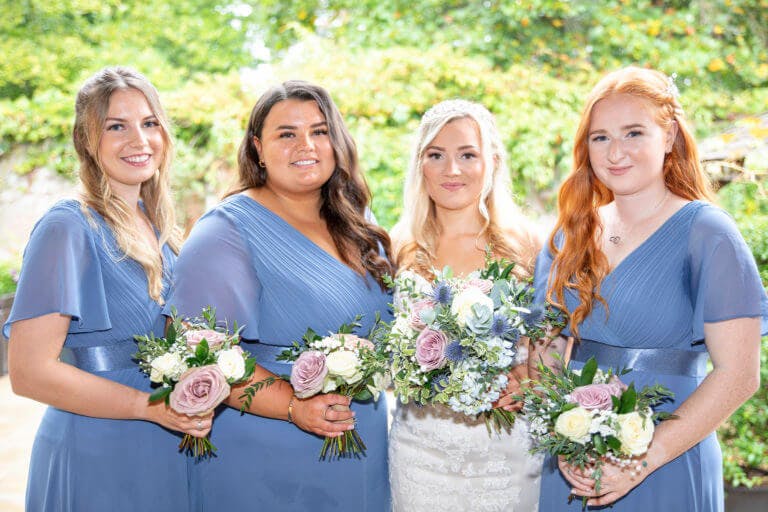 Bridesmaids and the bride outside at Careys Manor Hotel, New Forest