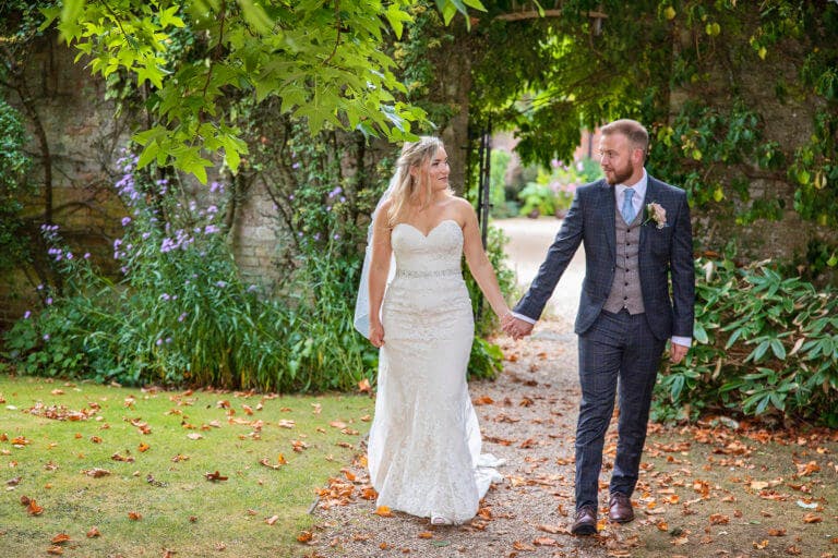 wedding couple in the garden at Careys Manor Hotel & SenSpa