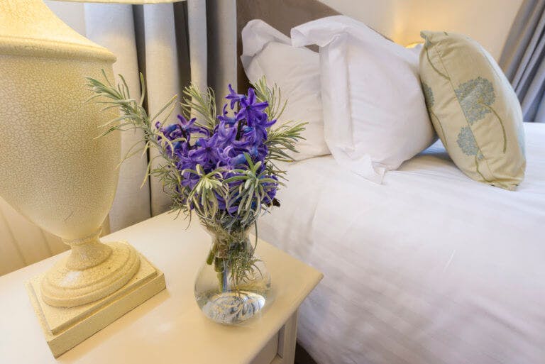 Purple flowers on bedside table 