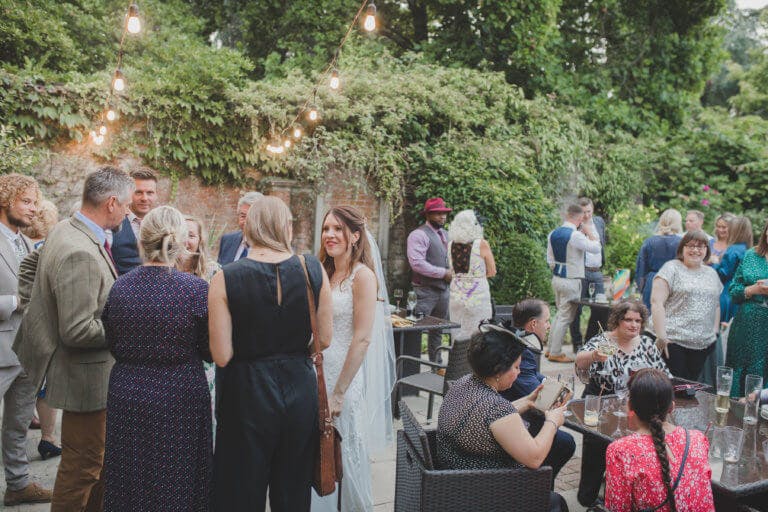 Guests gather to talk and enjoy the Cedar Garden at Hampshire Wedding venue Careys Manor Hotel