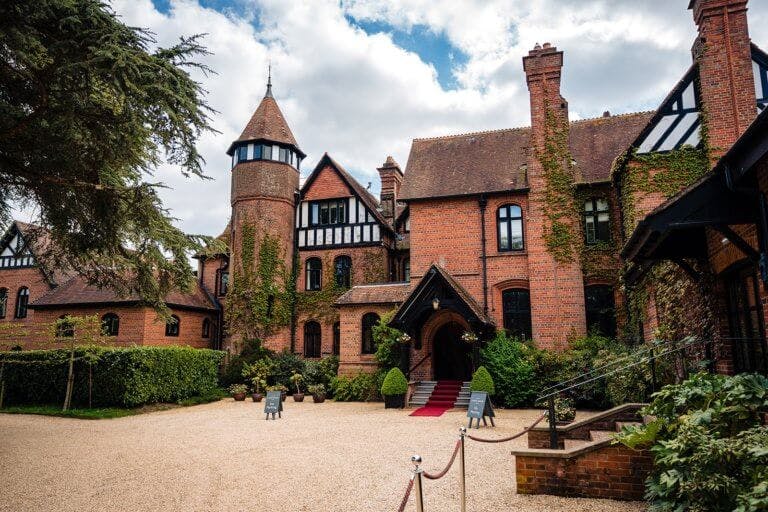 Exterior image of Careys Manor Hotel with the red carpet laid out