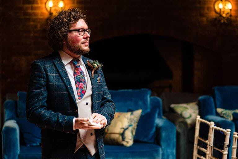 The Groom waiting at the end of the aisle for the Bride to enter the ceremony room