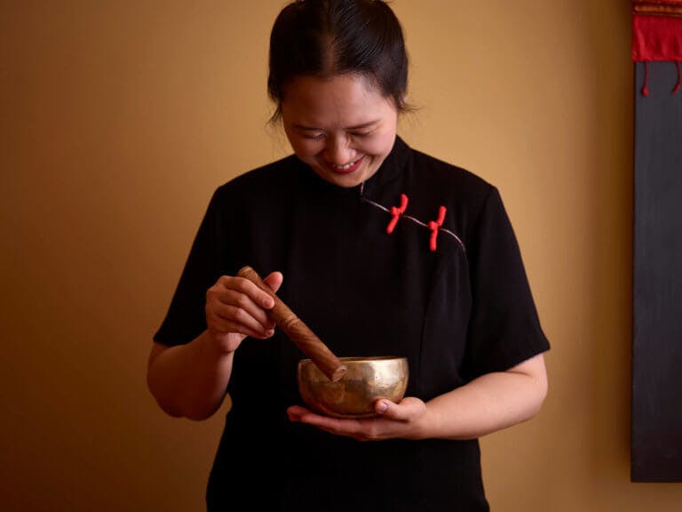 A SenSpa therapist with a sound bowl