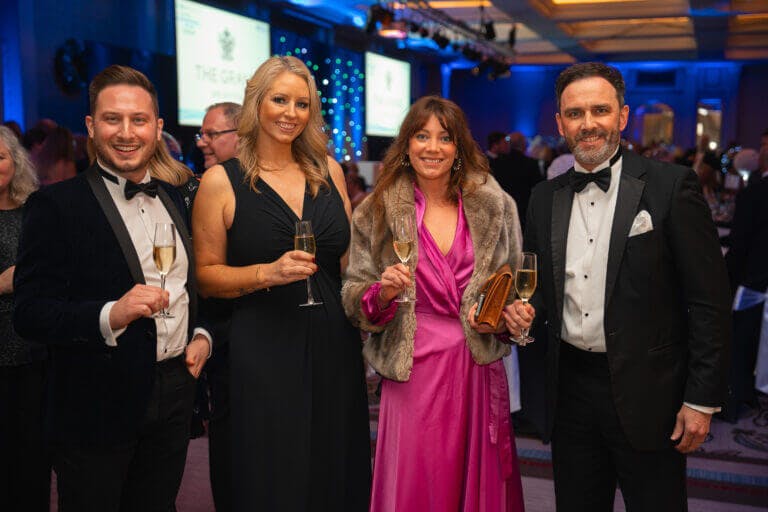 Team members in black tie at awards ceremony