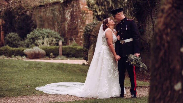 Bride & groom pose in the garden