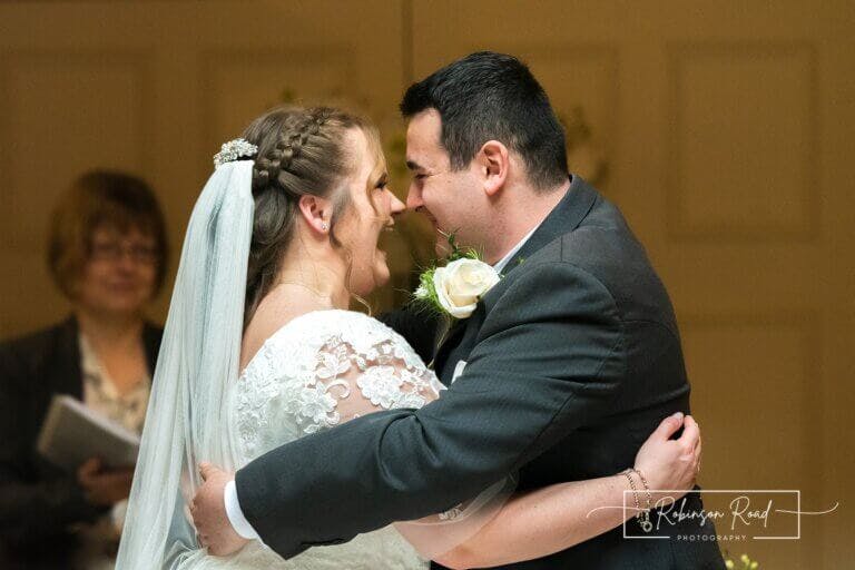 Bride and groom looking lovingly at each other in an embrace at Careys Manor Hotel & SenSpa wedding venue in The New Forest
