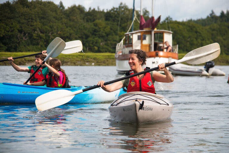 Family group kayaking in the river