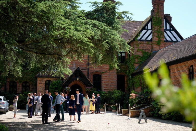 Guests gather and mingle on the front lawns of Careys Manor Hotel