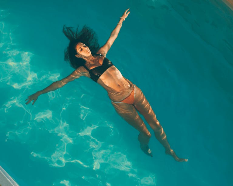 Woman in bikini floating in pool