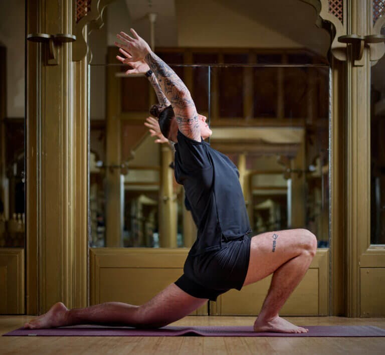 SenSpa personal trainer in yoga pose leading a fitness class in the studio