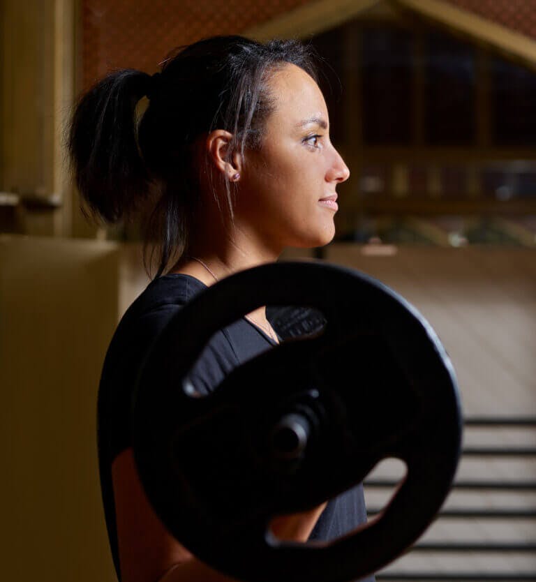 SenSpa member weightlifting in fitness studio during Body Pump Class