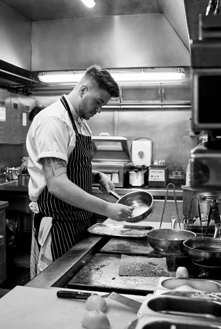 Chef cooking in the Careys Manor Hotel & SenSpa kitchen
