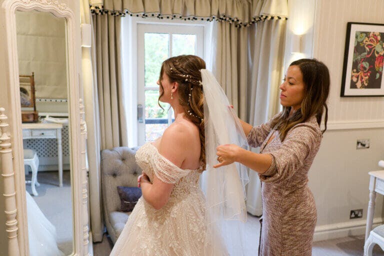 The brides friend attached her veil in front of a mirror