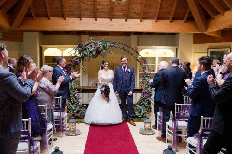 The bride & groom walk up the aisle after the wedding ceremony