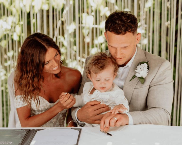 Oliver & Olivia wedding, at registrars table with their baby boy