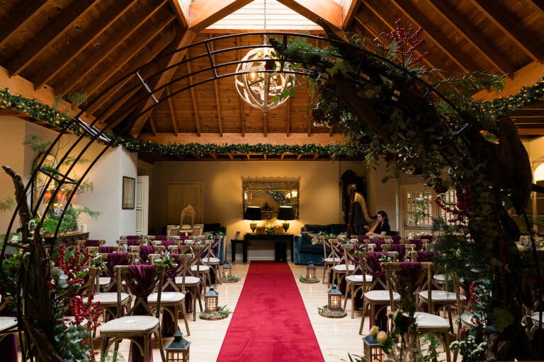 View from behind the registrars table looking towards the back of the room at Maxine & Alastair's wedding at Hampshire wedding venue Careys Manor Hotel & SenSpa.