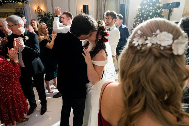 The bride and groom, Maxine & Alastair's embrace and share a kiss on the dance floor.