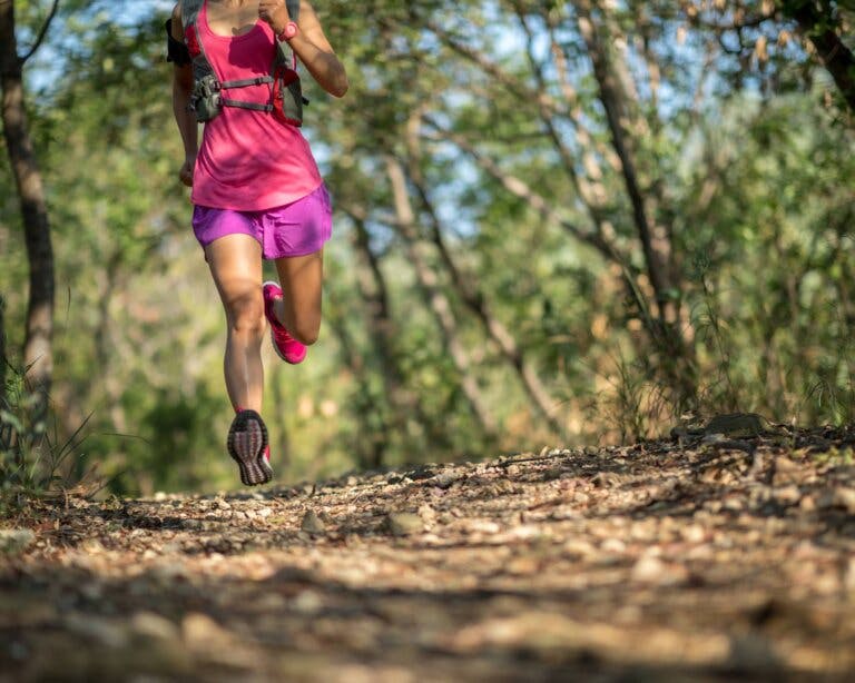 Woman running through the forest