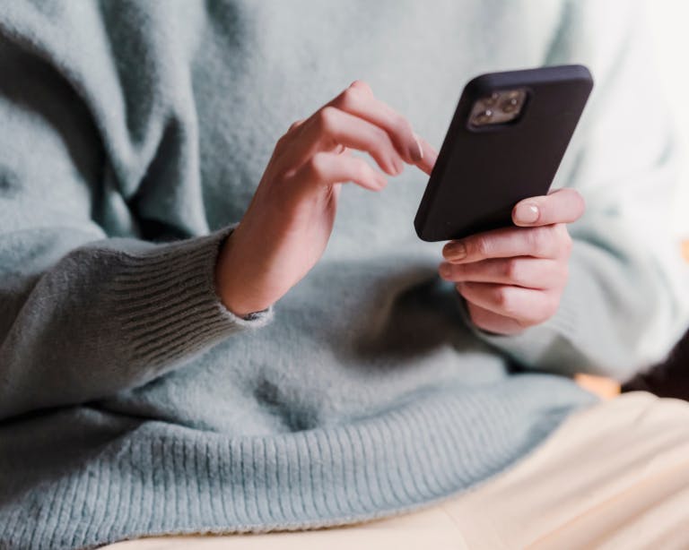 Woman scrolling on phone. Digital Detox spa break SenSpa.
