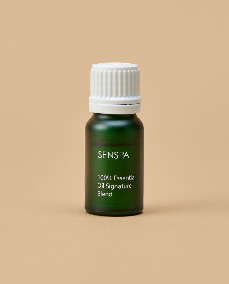 A small green bottle containing SenSpa 100% Essential Oil Signature Blend