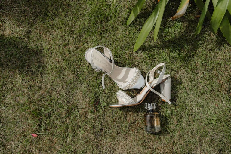 wedding shoes and perfume on the grass - taken from above.