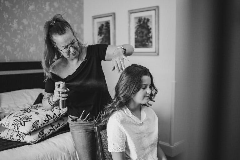 Young Bridesmaid having her hair done by stylist