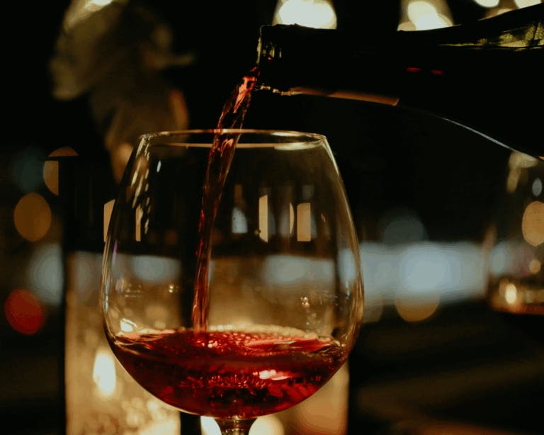 Red wine being poured at a restaurant