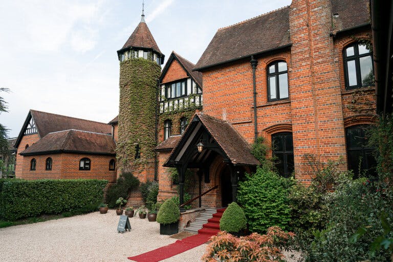 Outside of Careys Manor with the red carpet coming from the main entrance