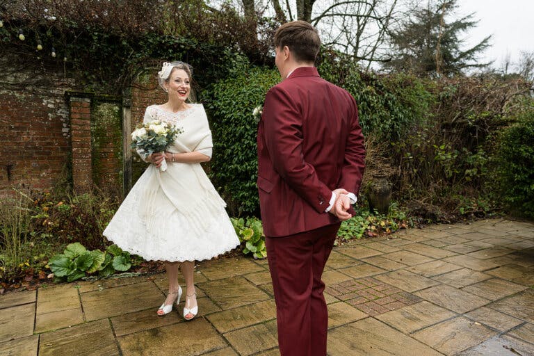 The brides stand in the garden, whilst Lottie twirls in her dress and Lily looks on