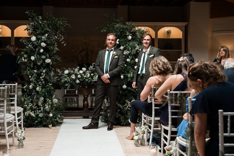 Guests are seated whilst the groom stands at the alter waiting for the bride.