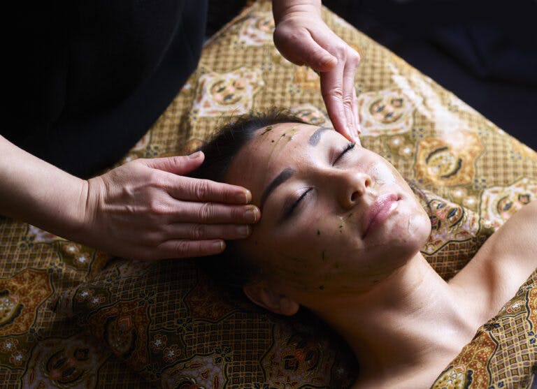 Woman receives Eminence Super Greens Facial treatment at Senspa