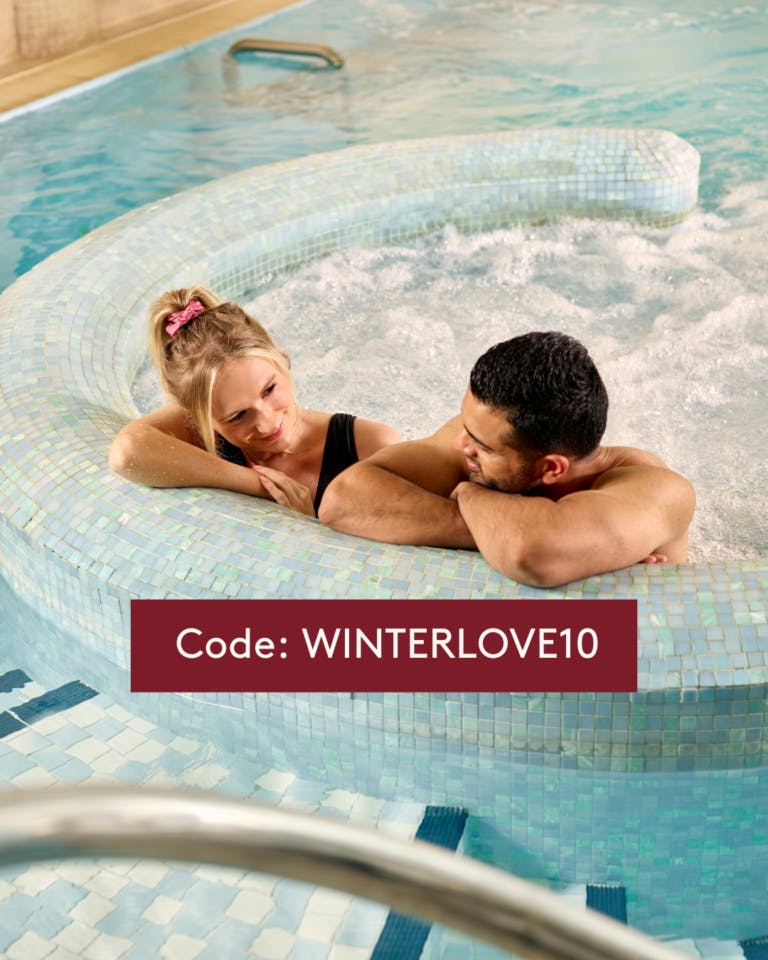 Couple relaxing in Jacuzzi with spa promo code