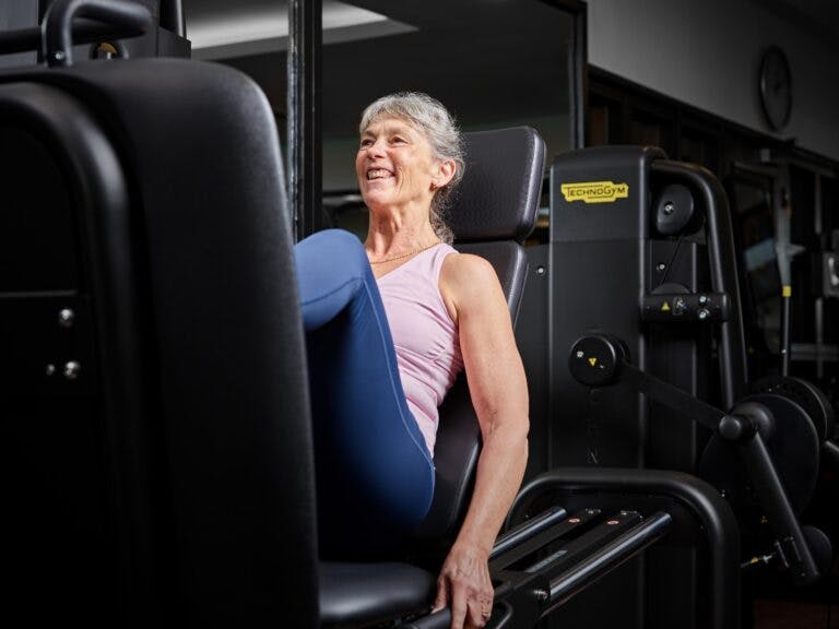 Woman uses leg press at TechnoGym fitness suite in SenSpa