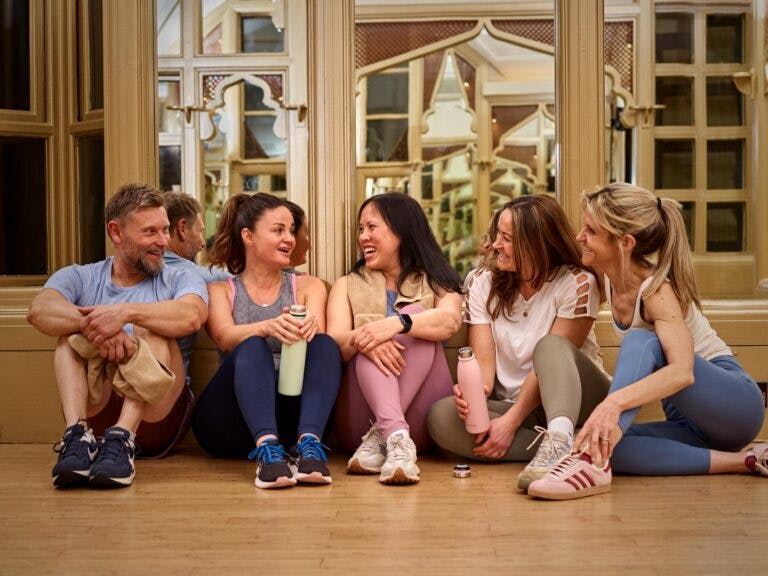Group of members relaxing together in SenSpa studio after fitness class