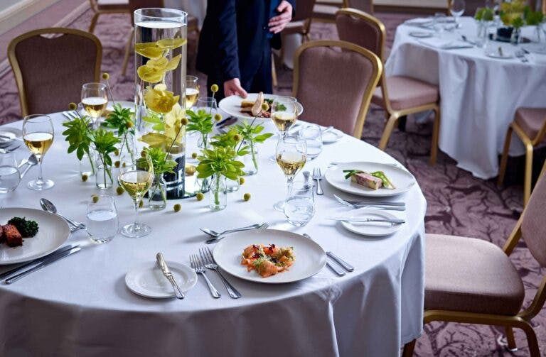 Dining table set up for conference dinner at hotel