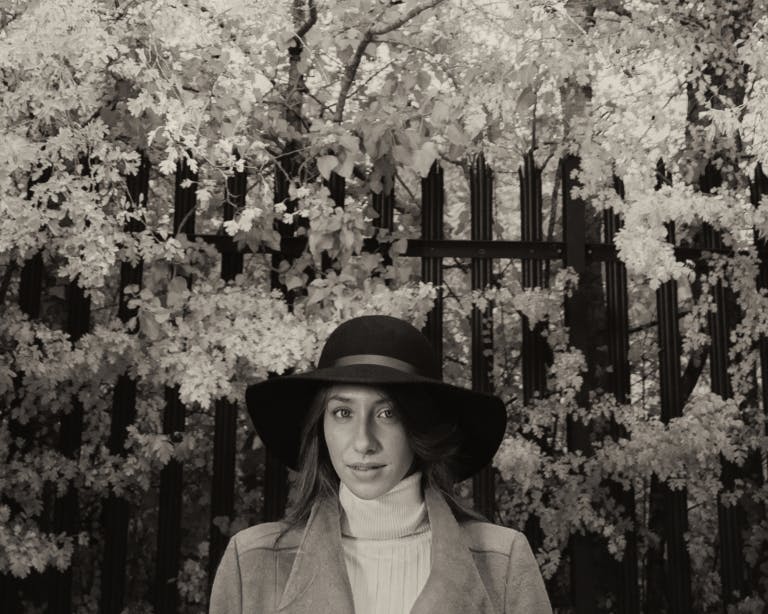 Black and white portrait of woman under blossom tree