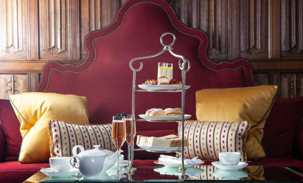 Tiered traditional afternoon tea cake stand with freshly baked scones and finger sandwiches in The Great Hall