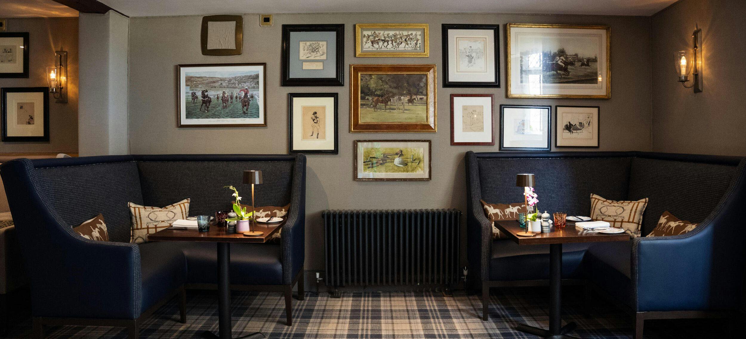 Rustic leather booth seating and equestrian artwork in the cosy Horse Box Brasserie and Bar