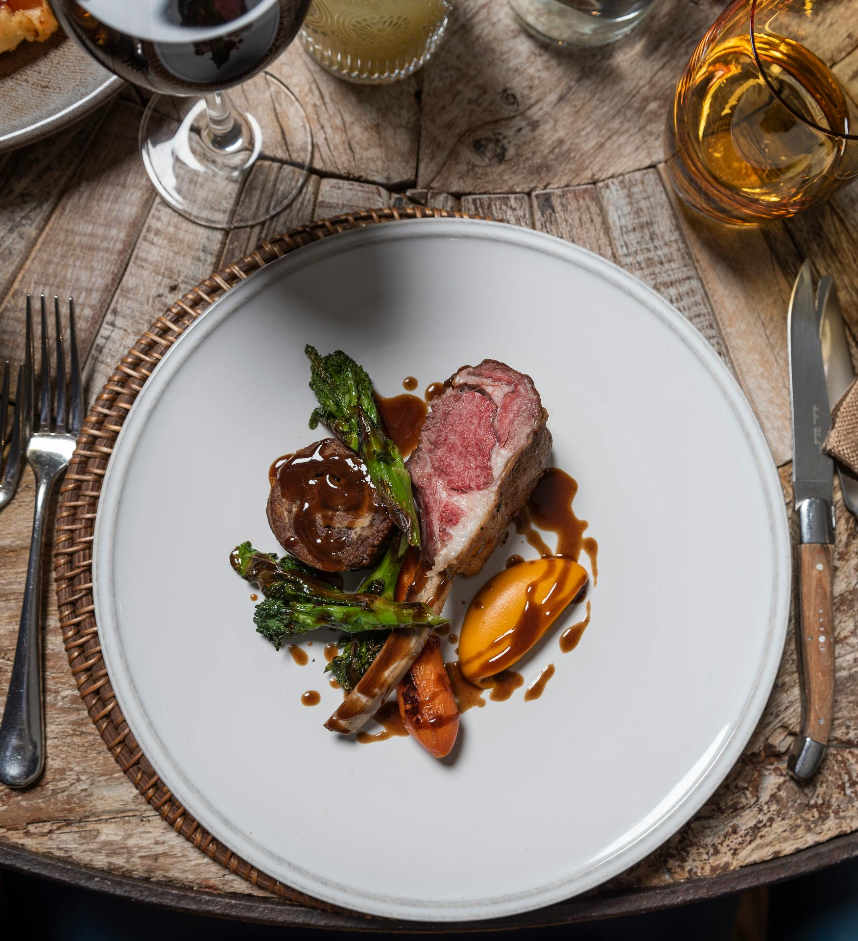 Snug bedroom tucked into garden wing eaves with warm lighting, king bed, and artisan textures